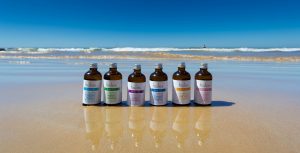 Holos body oils on Algarve beach