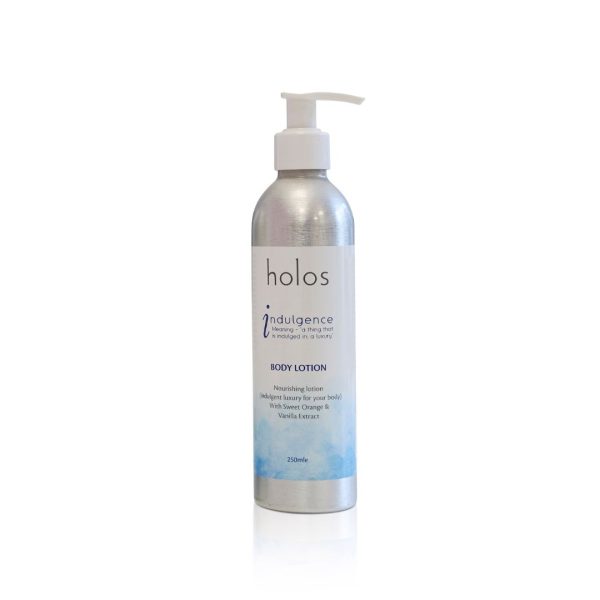 The elegant silver pump bottle of Holos Skincare's Indulgence Body Lotion stands out against a pristine white background. The label highlights its rich blend of sweet orange and vanilla extract, offering a 250ml indulgent experience